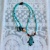 Perlenkette türkis/braun mit Hamsa Hand